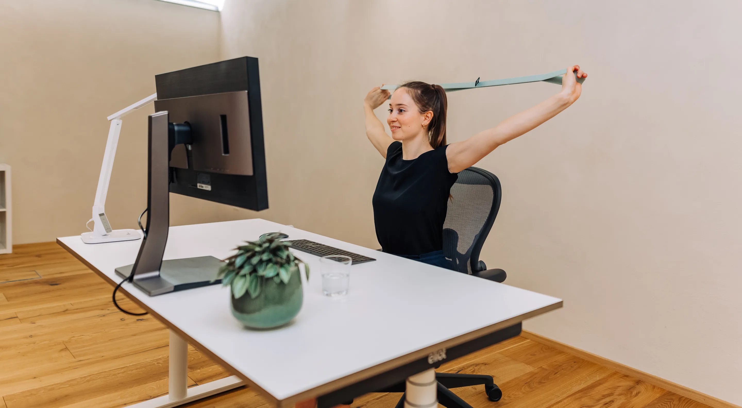 Office worker taking a short stretch at their desk